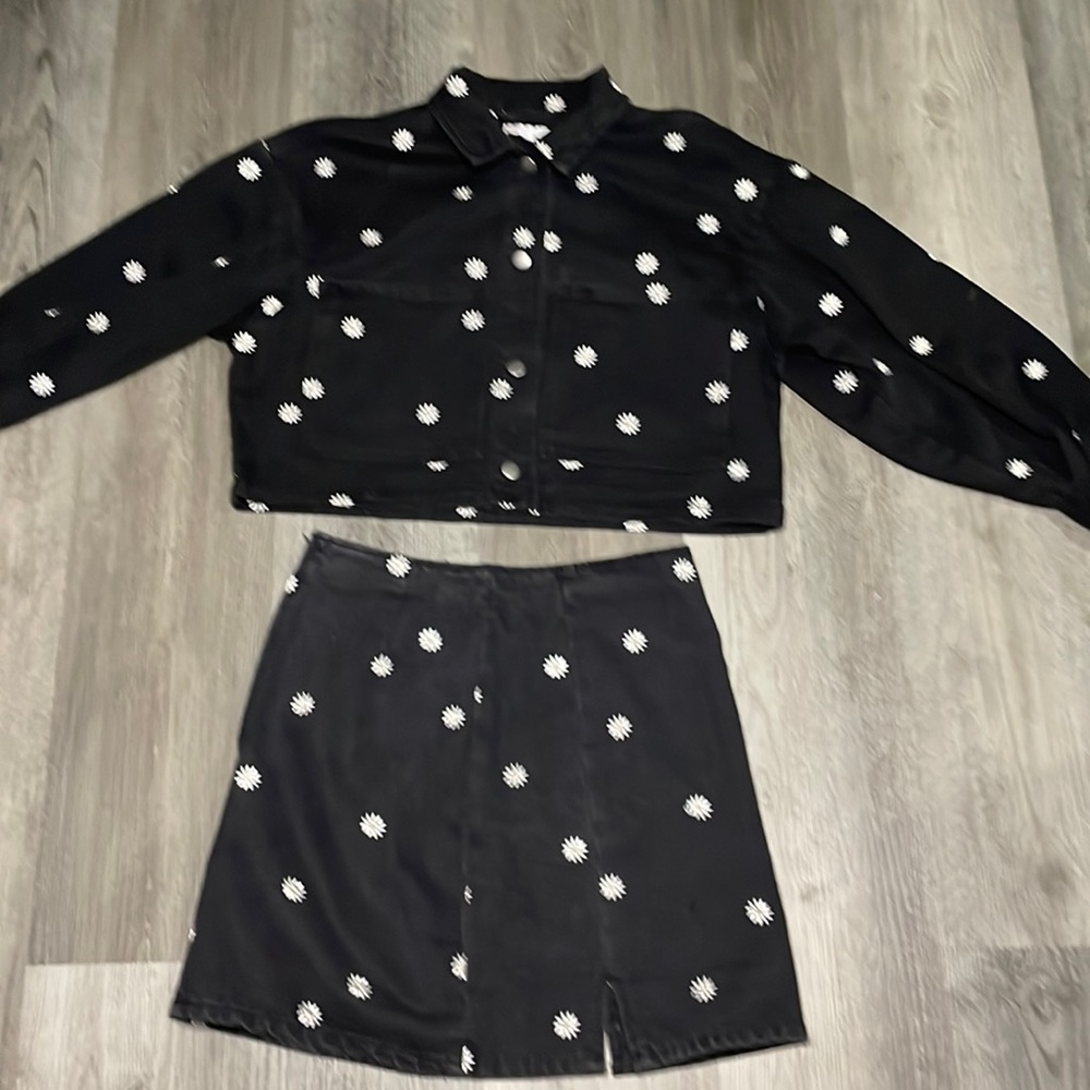 Two piece button up jean jacket with daisies on top and on the skirt